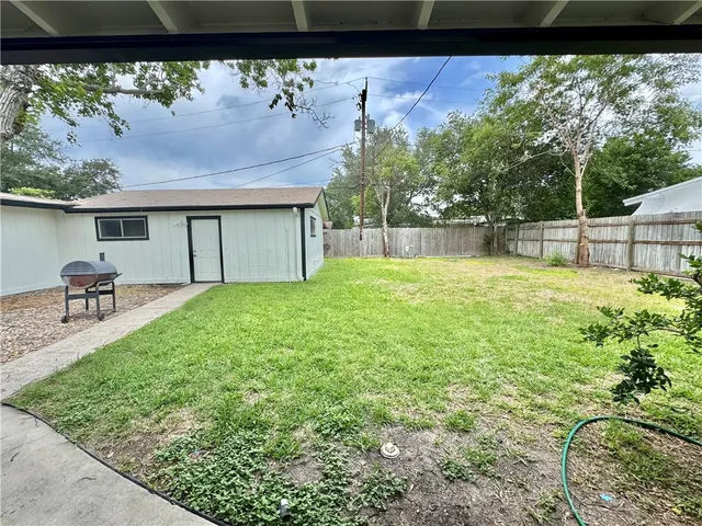 a view of a backyard with a garden and plants