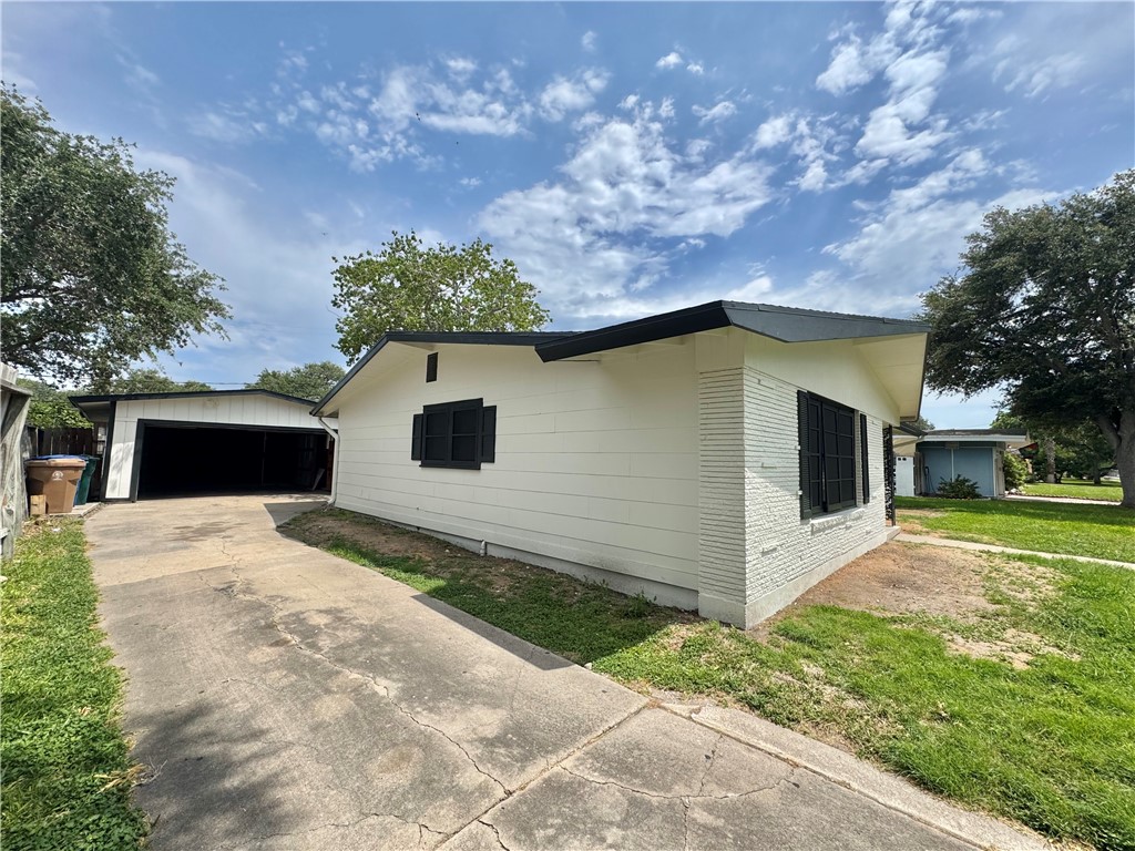 614 Dolphin Place Corpus Christi, TX 78411 - Photo 2 of 23 a front view of a house with a yard and garage