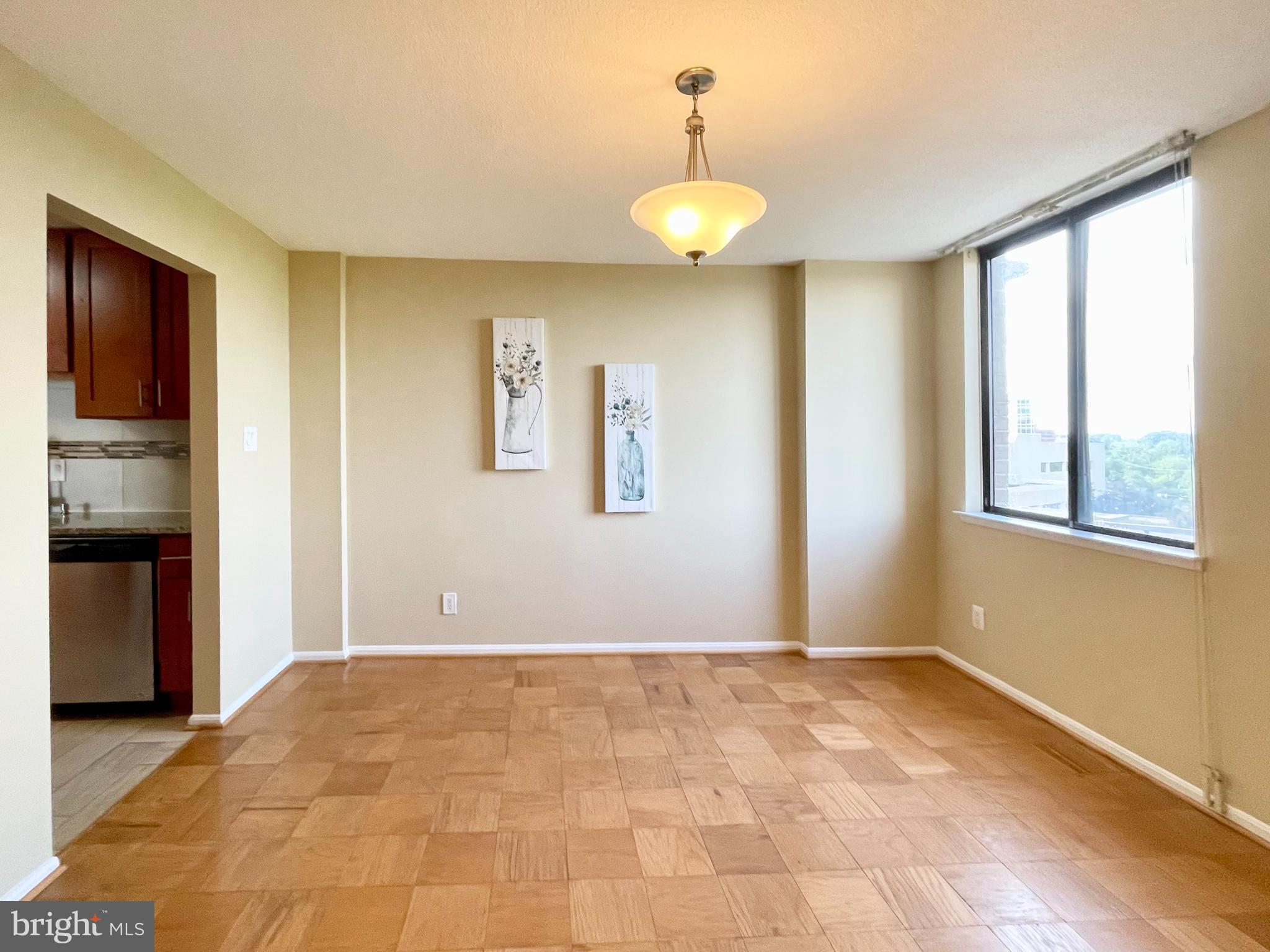 4 Monroe Street, Unit 802 Rockville, MD 20850 - Photo 18 of 44 a view of an empty room with window and wooden floor