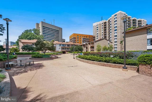 a front view of a building with garden and street view