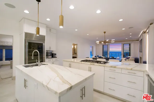 a kitchen with sink stove and cabinets