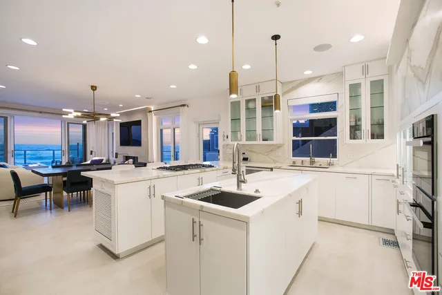 a kitchen that has a lot of cabinets in it and appliances