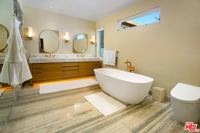 a bathroom with a double vanity sink and a mirror