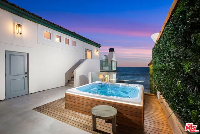 a front view of a house with table and chairs