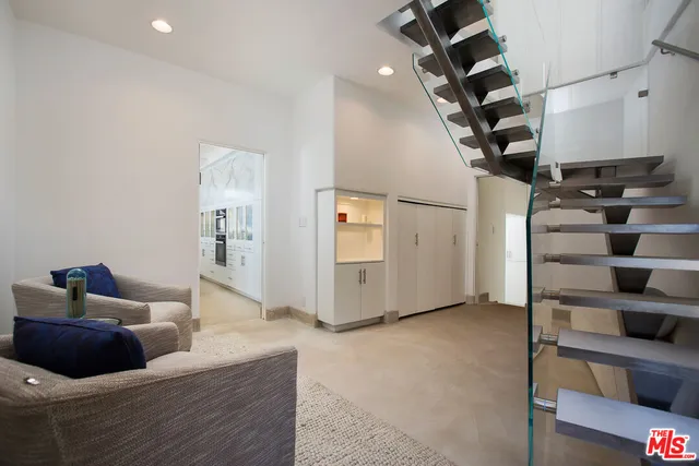 a bedroom with a large bed and a large window