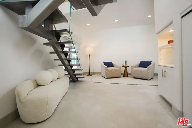 a bedroom with a bed and a large mirror