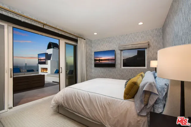 a bedroom with a large bed and a couch