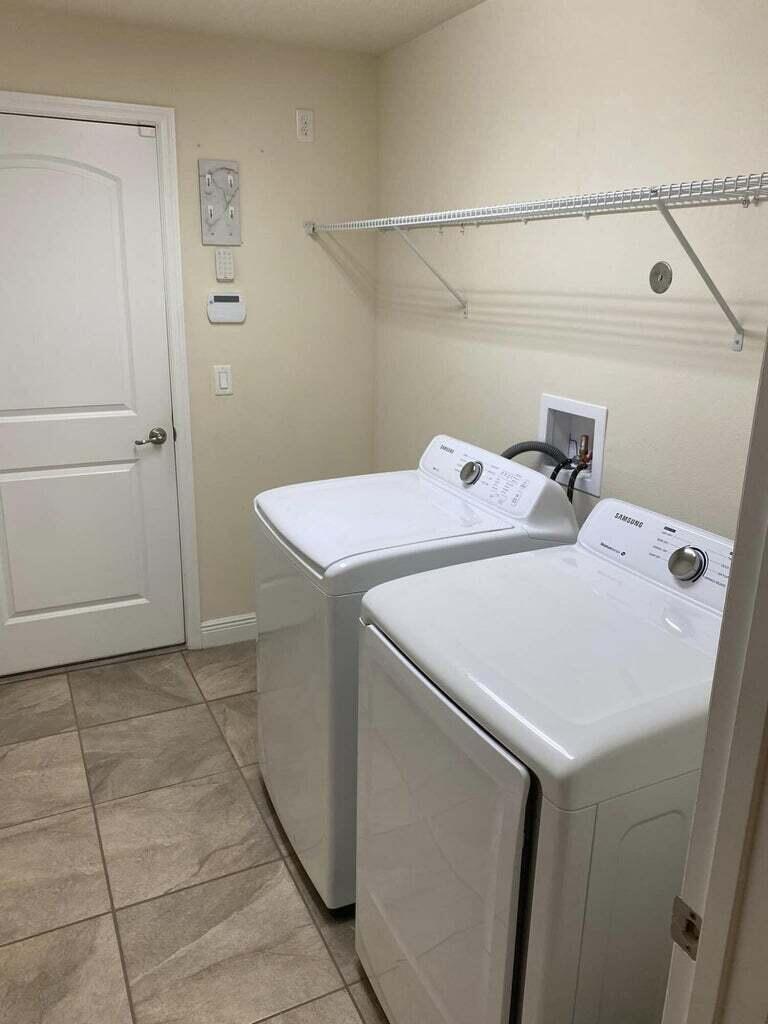 5910 Northwest Java Court Port St. Lucie, FL 34986 - Photo 16 of 16 a utility room with dryer and washer