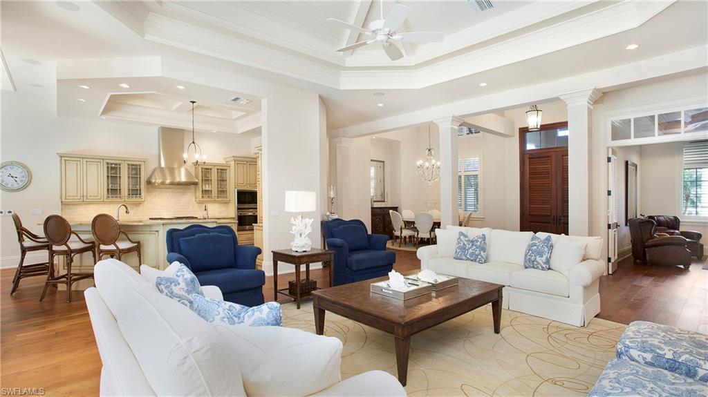 645 Rudder Road Naples, FL 34102 - Photo 11 of 45 a living room with furniture dining area and a chandelier