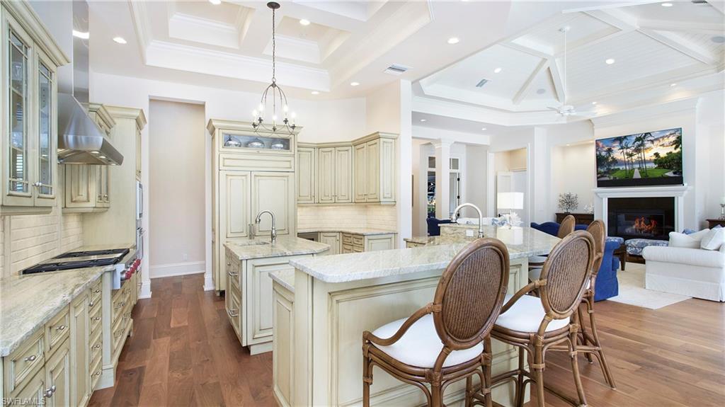 645 Rudder Road Naples, FL 34102 - Photo 12 of 45 a view of a dining room with furniture wooden floor and chandelier