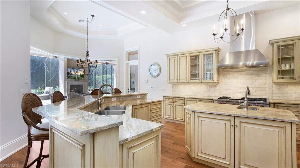 645 Rudder Road Naples, FL 34102 - Photo 14 of 45 a kitchen with stainless steel appliances granite countertop a sink a stove and a refrigerator