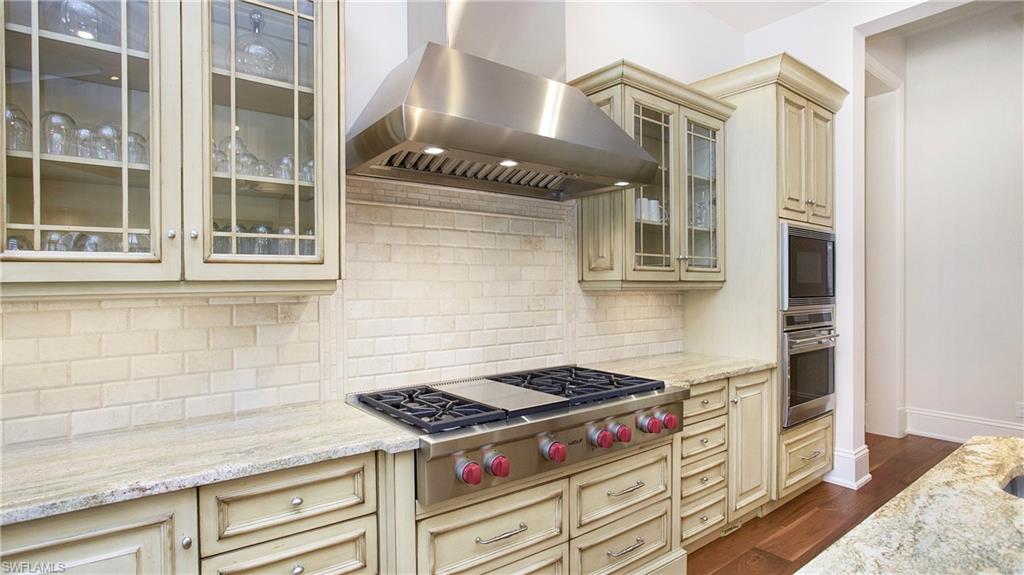 645 Rudder Road Naples, FL 34102 - Photo 16 of 45 a kitchen with a stove and a cabinet