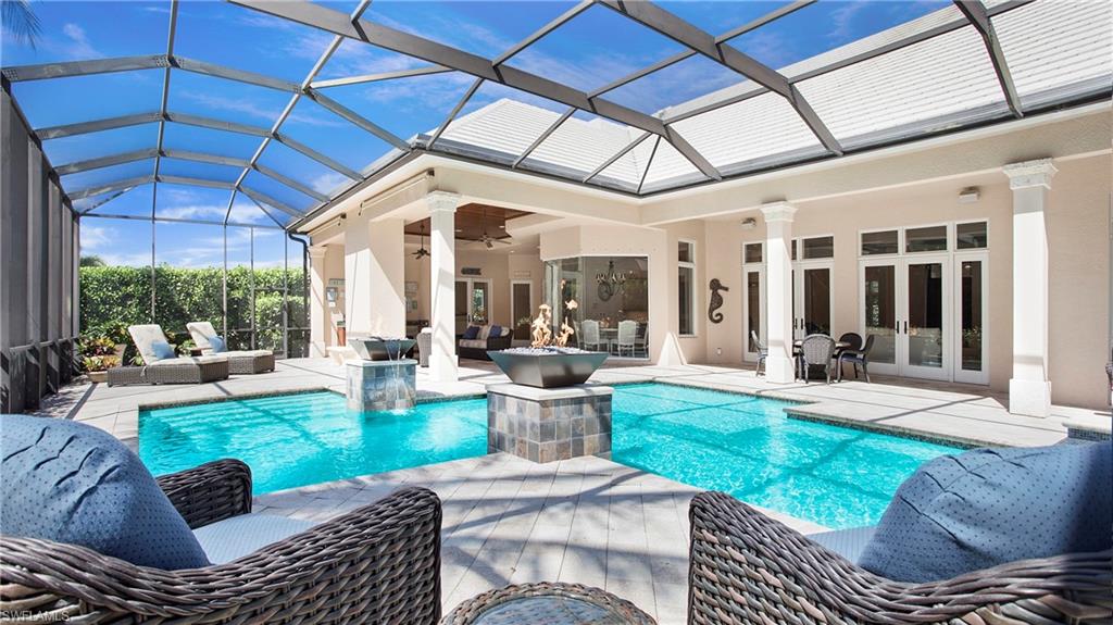 645 Rudder Road Naples, FL 34102 - Photo 2 of 45 a view of a patio with couches and chairs