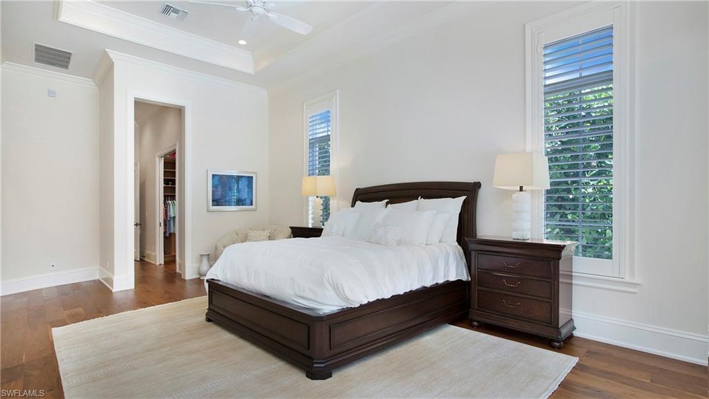 645 Rudder Road Naples, FL 34102 - Photo 21 of 45 a large bed sitting in a bedroom next to a window