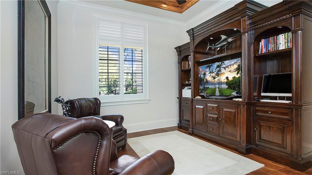 645 Rudder Road Naples, FL 34102 - Photo 26 of 45 a bedroom with a bed and a television