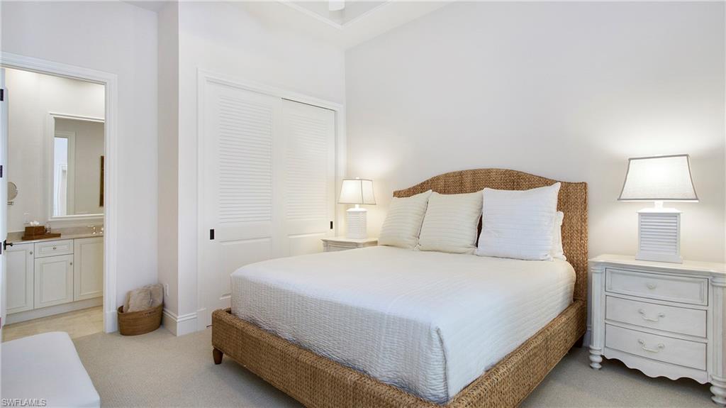 645 Rudder Road Naples, FL 34102 - Photo 33 of 45 a bedroom with a bed and a night stand