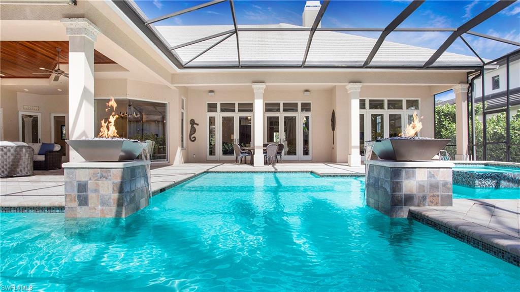 645 Rudder Road Naples, FL 34102 - Photo 36 of 45 a view of a building with a yard