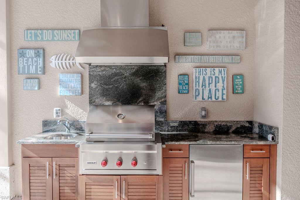 645 Rudder Road Naples, FL 34102 - Photo 41 of 45 a kitchen with a stove and a sink