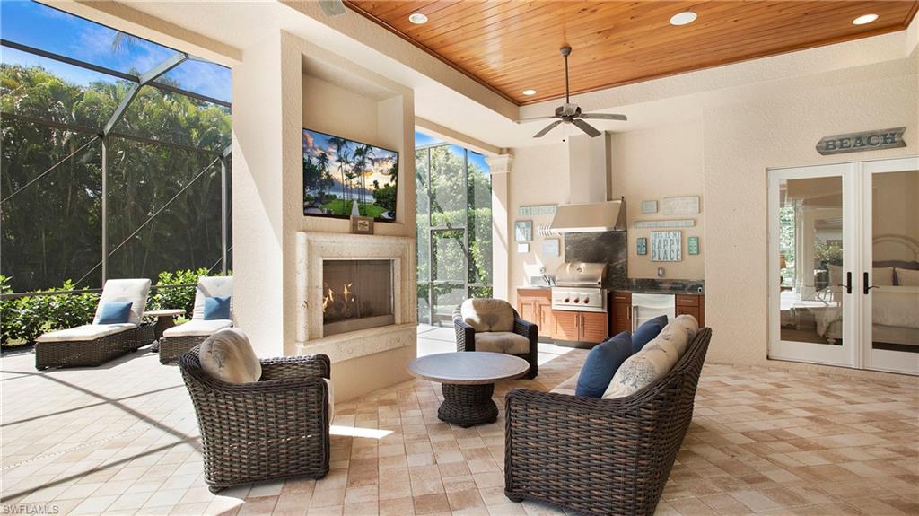 645 Rudder Road Naples, FL 34102 - Photo 42 of 45 a dining room with furniture a chandelier and glass door