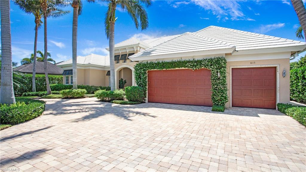 645 Rudder Road Naples, FL 34102 - Photo 45 of 45 a front view of a house with a yard and garage