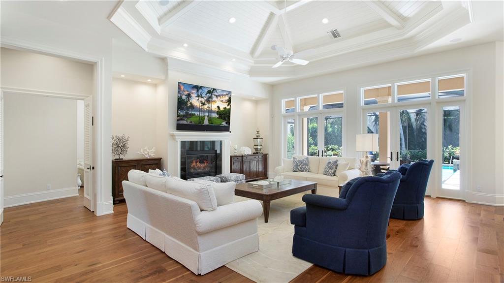 645 Rudder Road Naples, FL 34102 - Photo 10 of 45 a living room with fireplace furniture and a flat screen tv