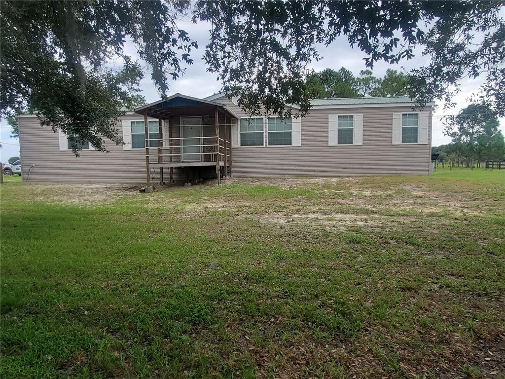 10 Ridge Road Frostproof, FL 33843 - Photo 1 of 1 a front view of a house with a garden