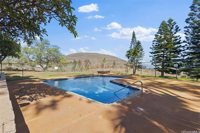 a view of a swimming pool with an outdoor seating