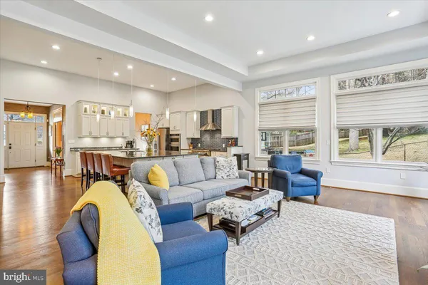 a dining room with furniture and a floor to ceiling window