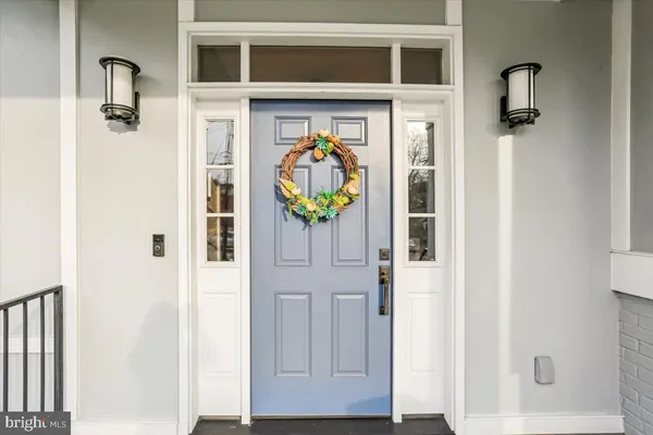 a view of front door with wooden floor and stairs