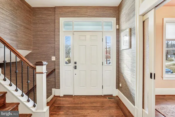 a kitchen with a dining table chairs and wooden floor