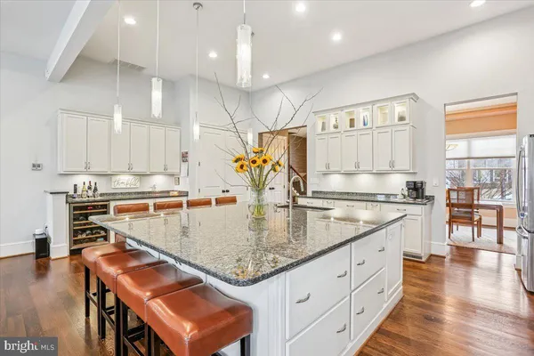a living room with furniture and view of kitchen
