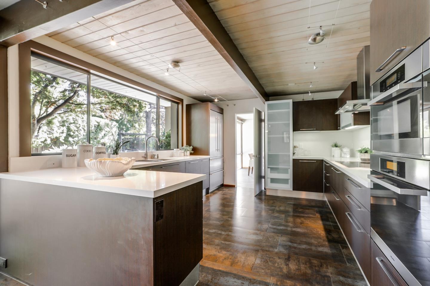 1614 Clay Drive Los Altos, CA 94024 - Photo 7 of 43 a kitchen with stainless steel appliances kitchen island granite countertop a sink and wooden cabinets