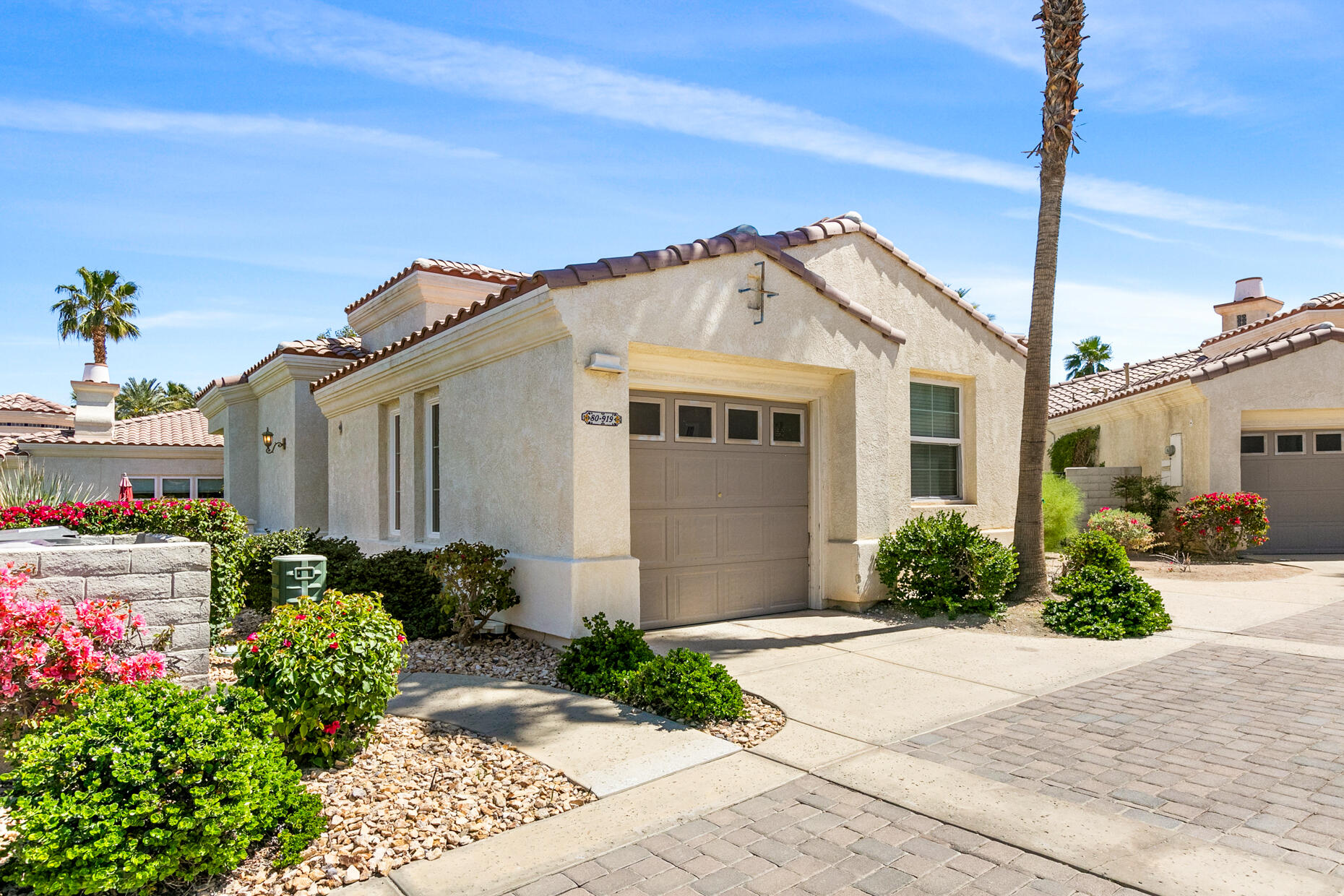 80919 Via Puerta Azul La Quinta, CA 92253 - Photo 20 of 32 a front view of a house with garden