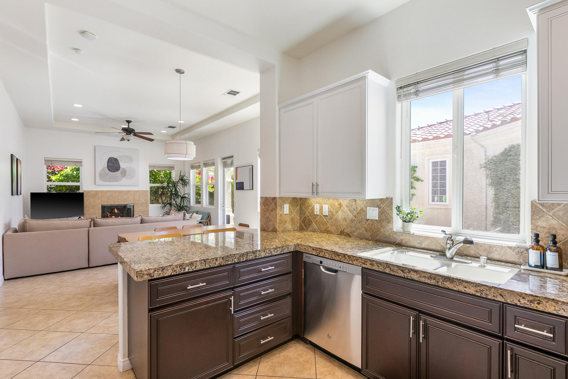 80919 Via Puerta Azul La Quinta, CA 92253 - Photo 5 of 32 a kitchen with granite countertop a sink and a stove