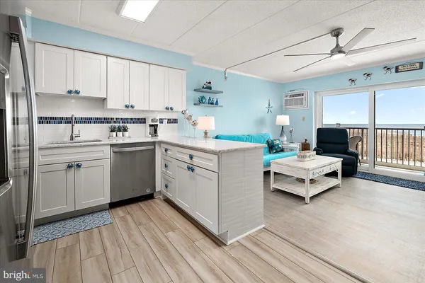 a kitchen with a sink a window and cabinets