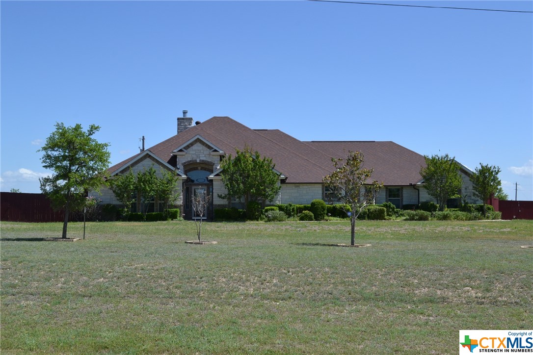 a house that has a tree in front of it