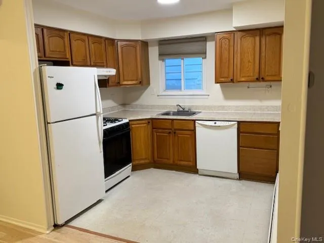 a white refrigerator freezer sitting in a kitchen