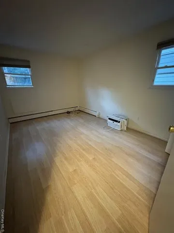 a view of a room with wooden floor