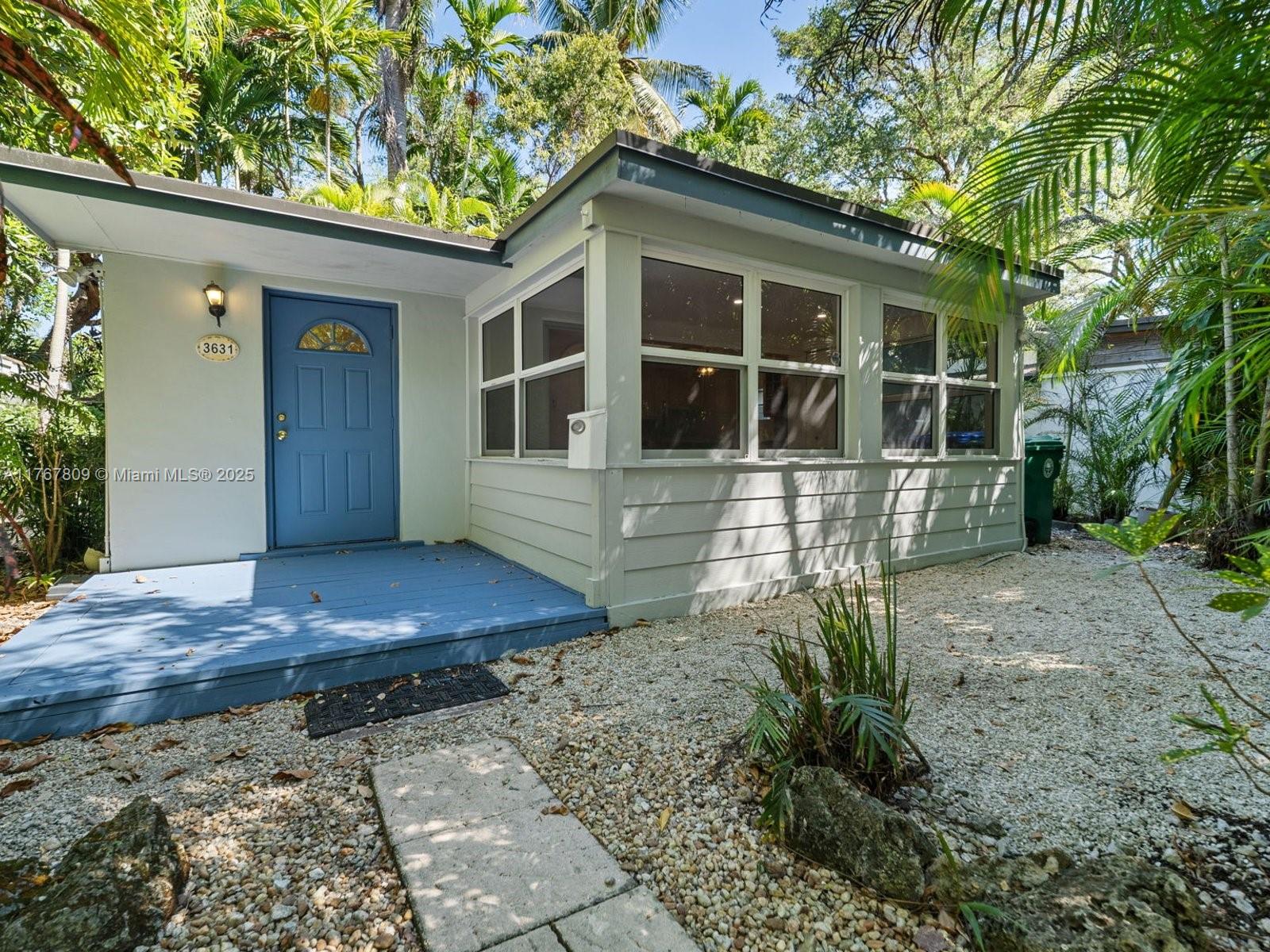 3631 Loquat Avenue Miami, FL 33133 - Photo 1 of 31 a front view of a house with a yard