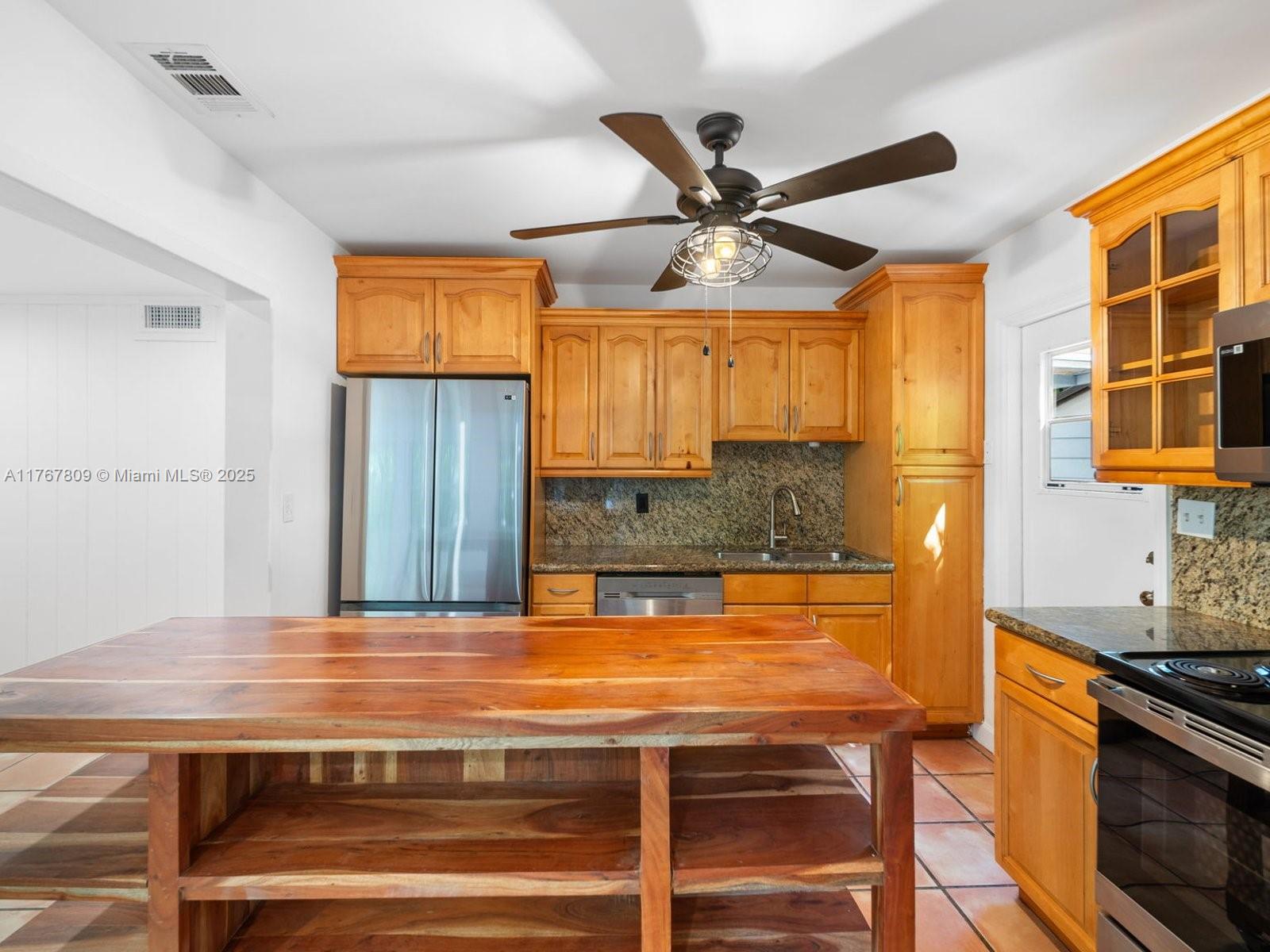 3631 Loquat Avenue Miami, FL 33133 - Photo 16 of 31 a view of a kitchen with a sink and a stove top oven