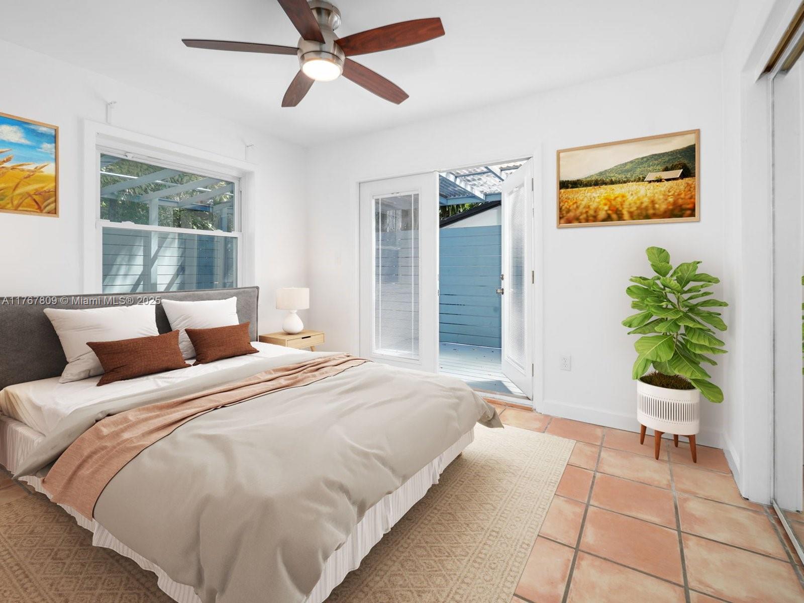 3631 Loquat Avenue Miami, FL 33133 - Photo 19 of 31 a bedroom with a bed and a couch