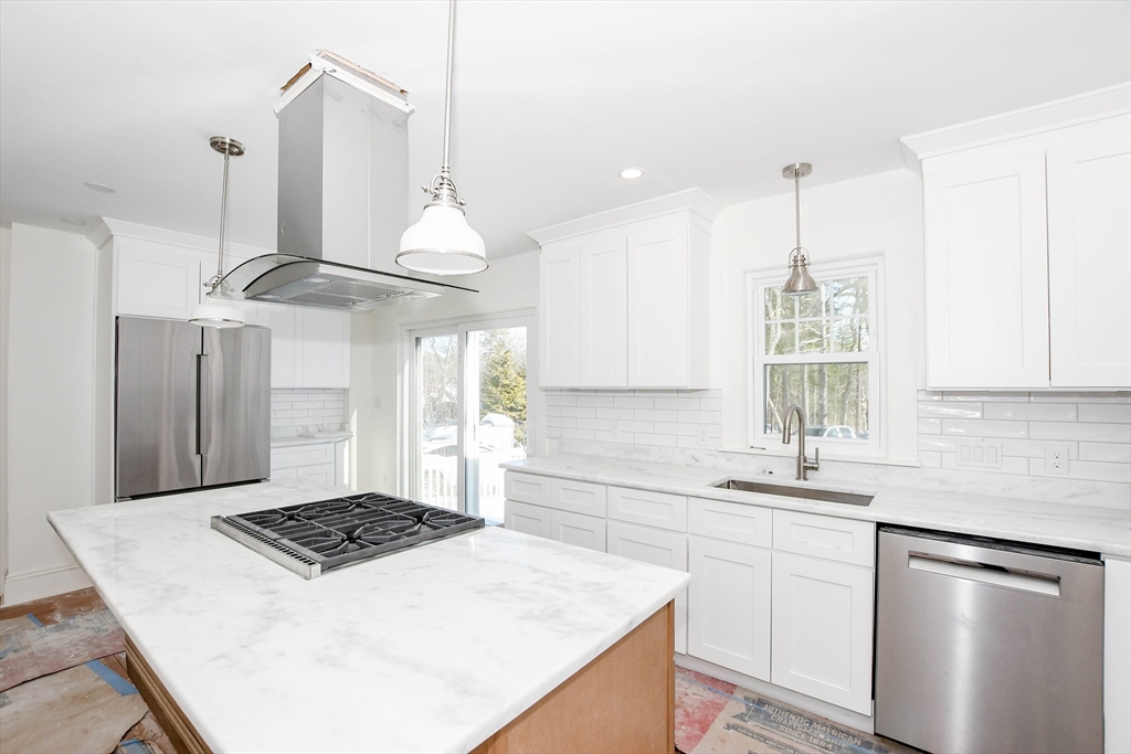 3 Pleasant Street Marion, MA 02738 - Photo 6 of 14 a kitchen with stainless steel appliances a stove a sink and a refrigerator