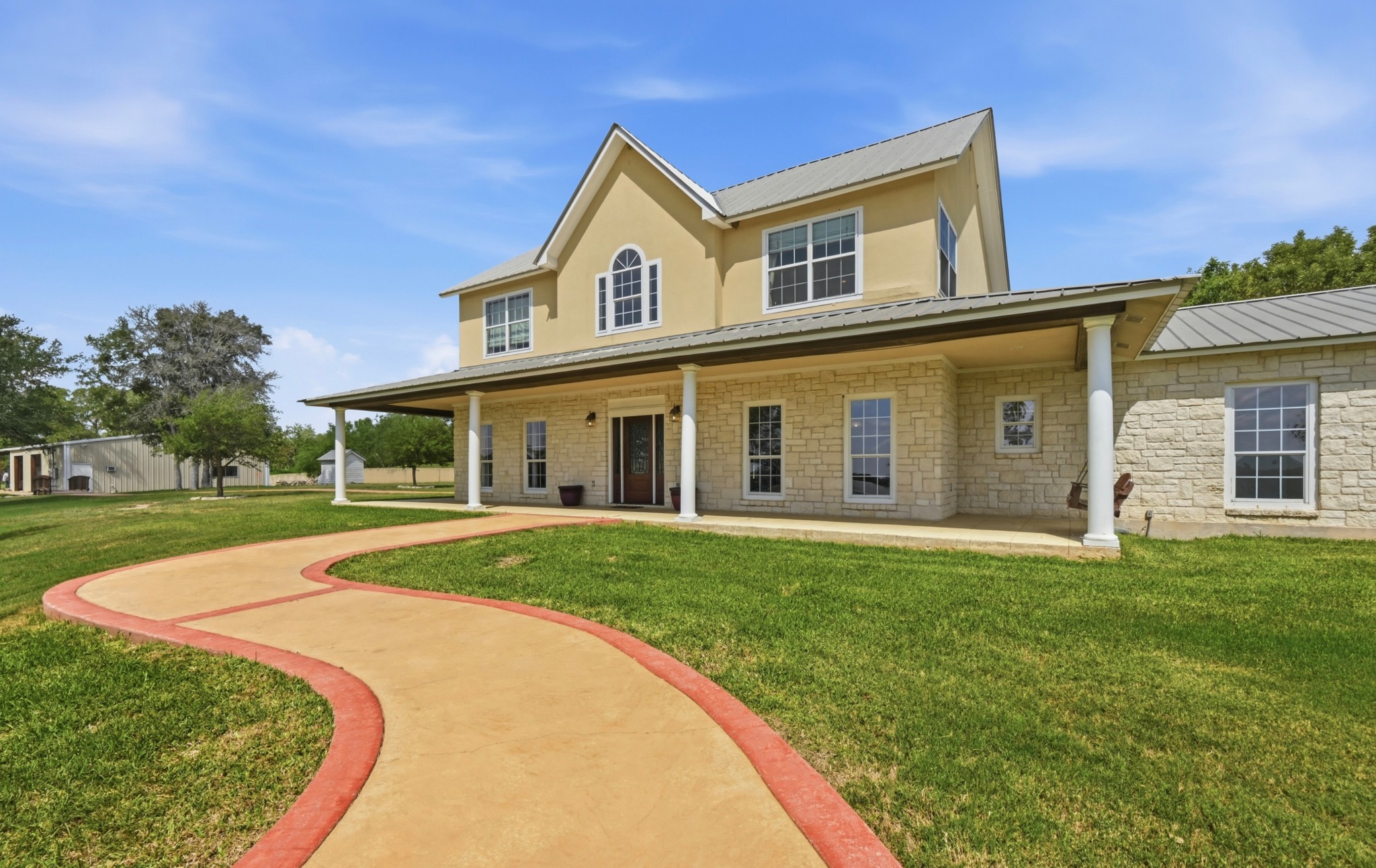 1175 Southern Way Luling, TX 78648 - Photo 4 of 40 A graceful paved path guides to this inviting two-story residence with a wide, columned front porch.
