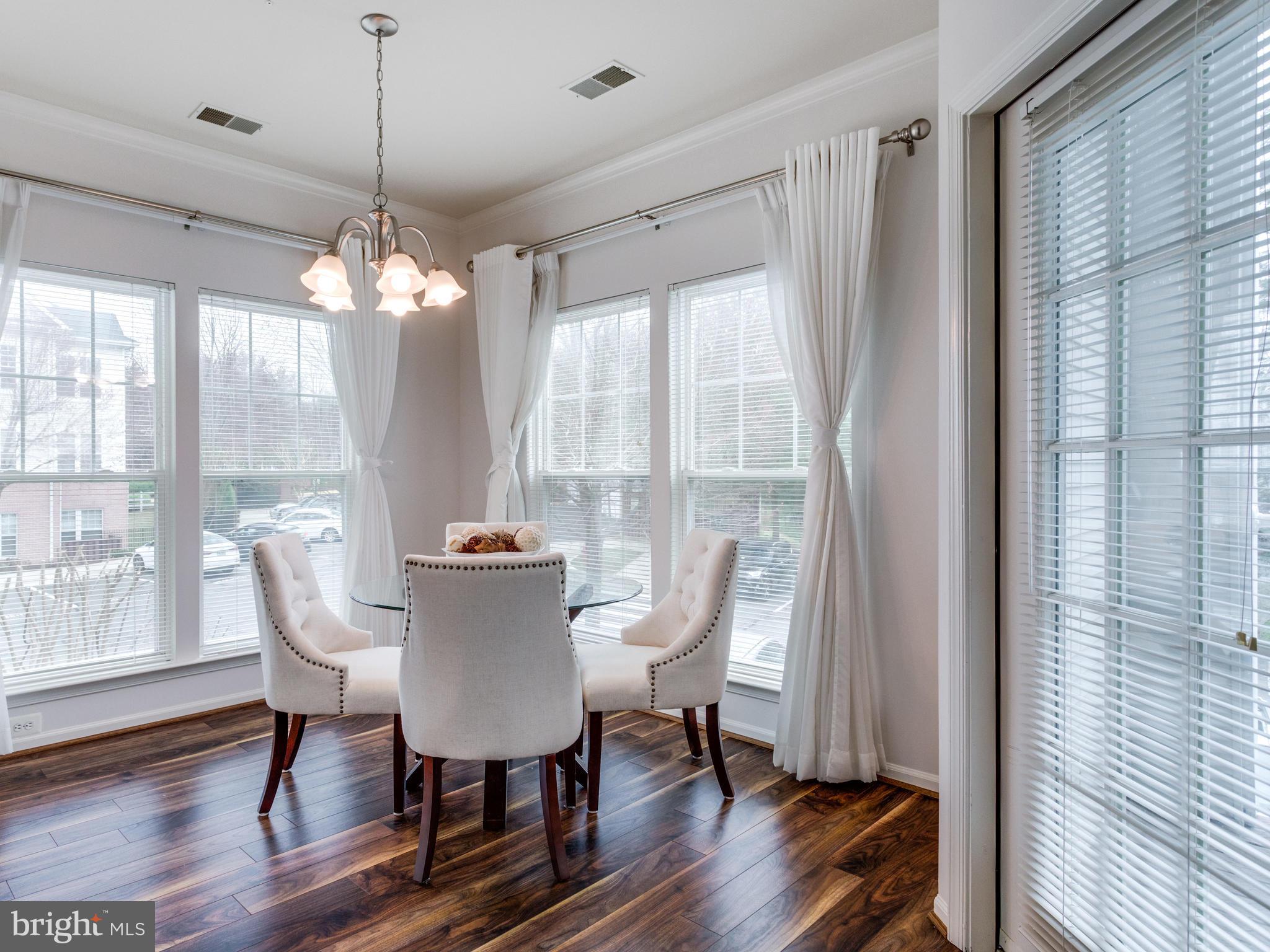 1520 North Point Drive, Unit 201 Reston, VA 20194 - Photo 6 of 30 Floor to ceiling windows in Dining Room