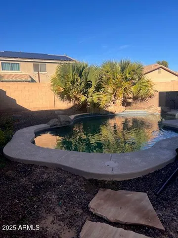 a view of a swimming pool with an outdoor space and seating area