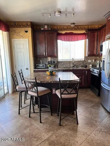 a view of a dining room with furniture and window