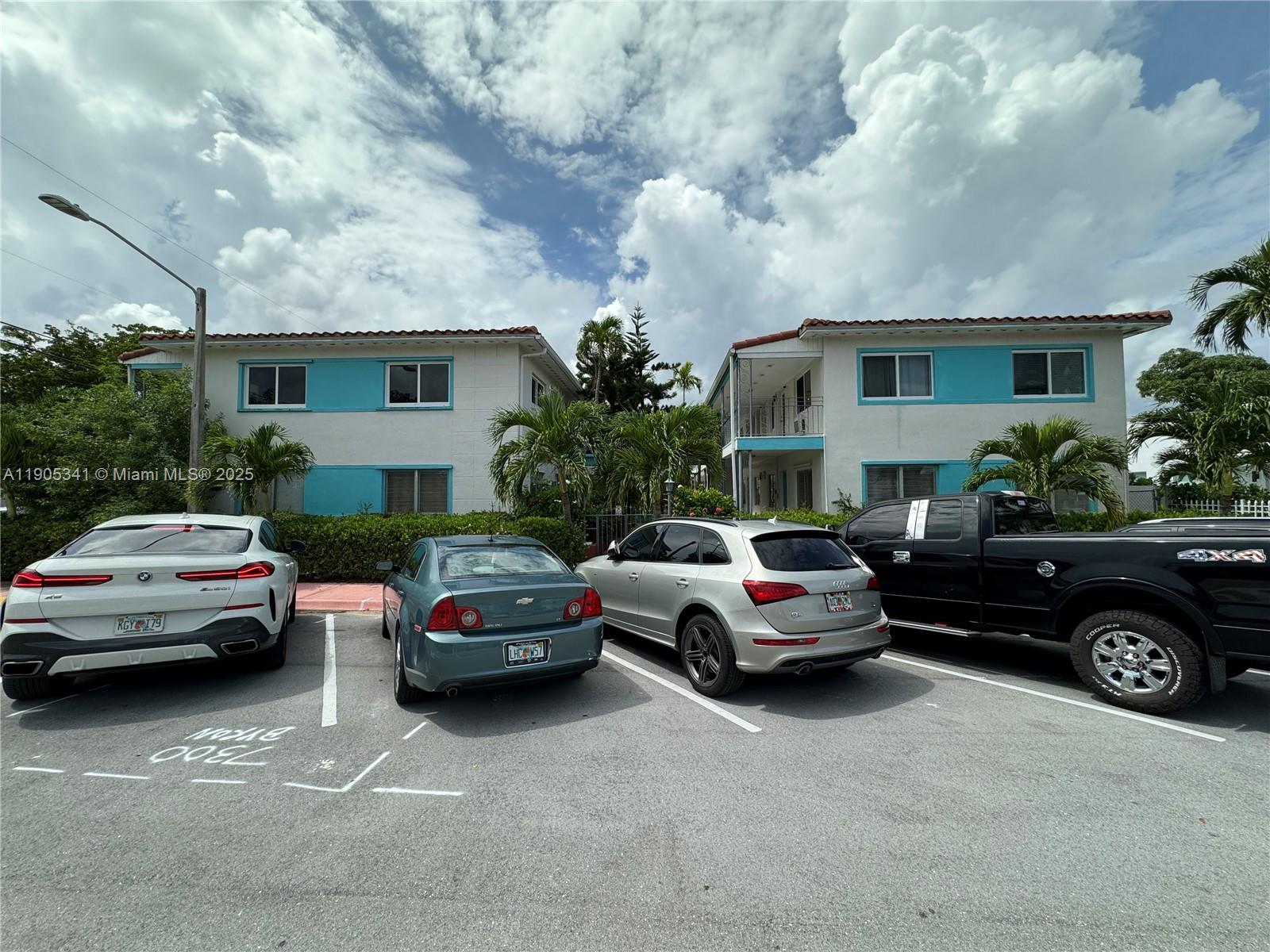 7300 Byron Avenue, Unit 10 Miami Beach, FL 33141 - Photo 1 of 10 a cars parked in front of a house
