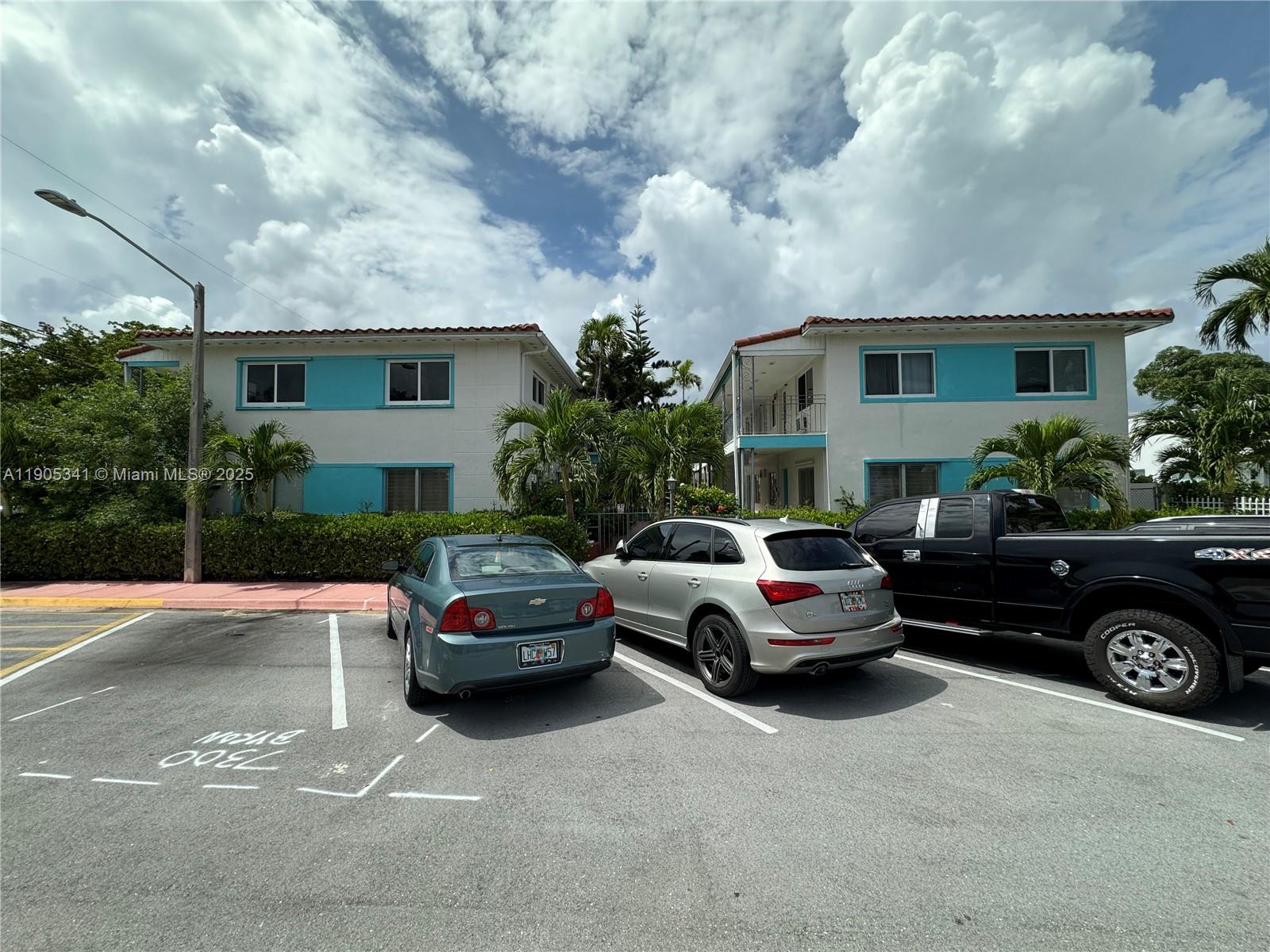 7300 Byron Avenue, Unit 10 Miami Beach, FL 33141 - Photo 2 of 10 a cars parked in front of a house