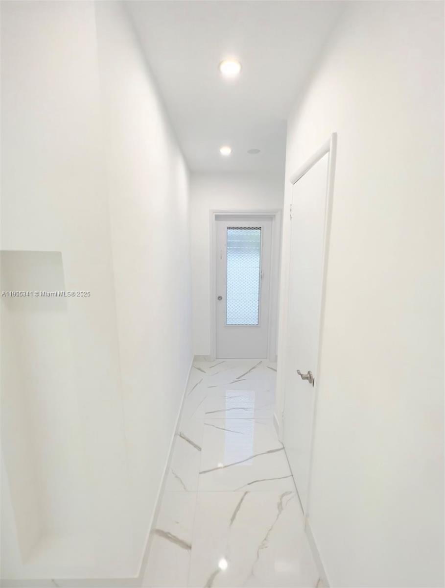 7300 Byron Avenue, Unit 10 Miami Beach, FL 33141 - Photo 6 of 10 a view of a hallway