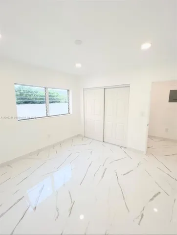 an empty room with a empty space and windows